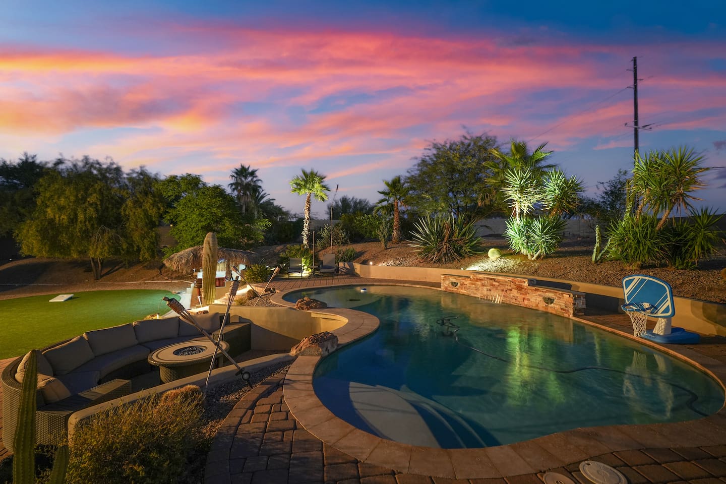 Golden-hour pool scene showcasing the tranquil desert setting and open skies.