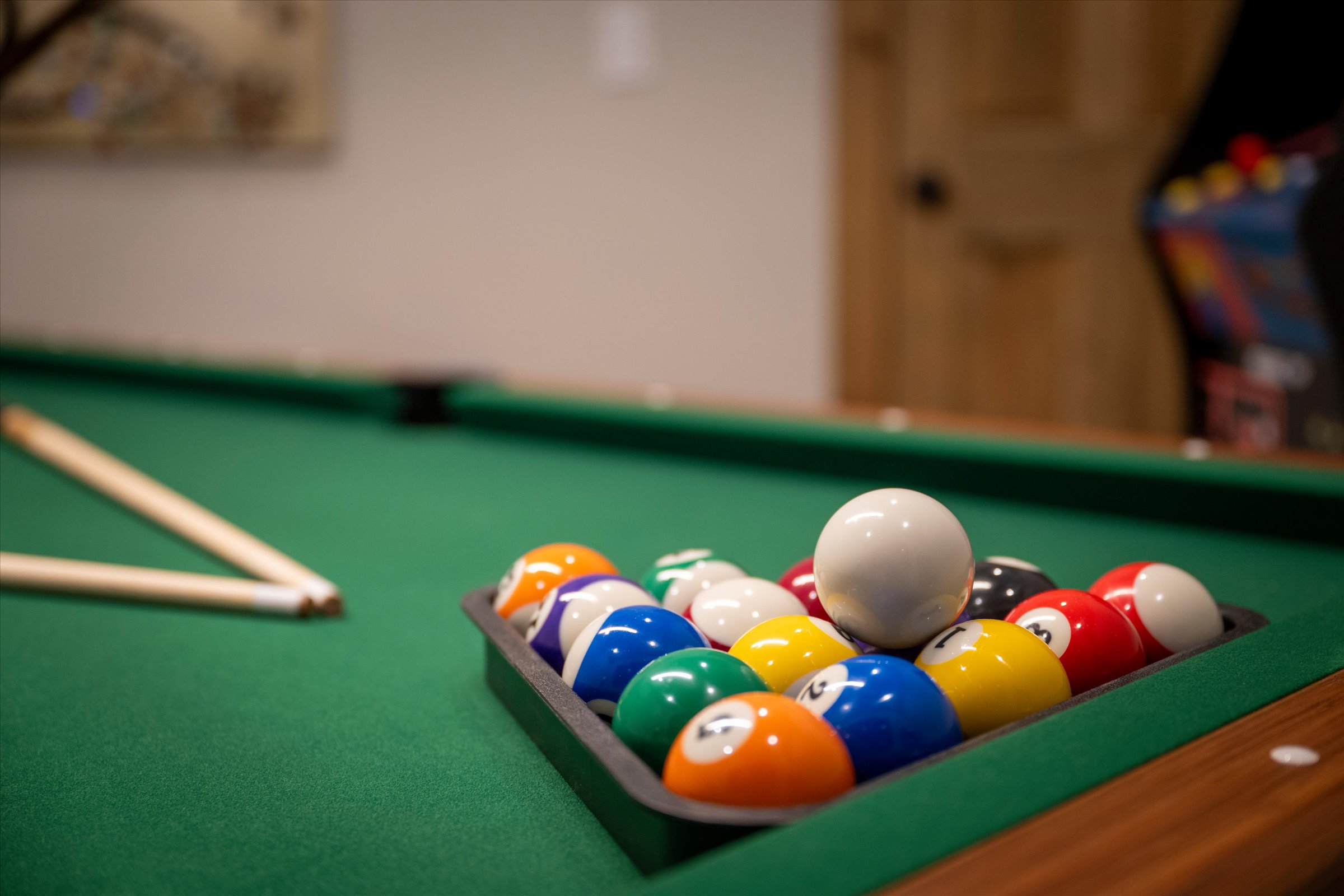 Full-sized pool table located in the game room.