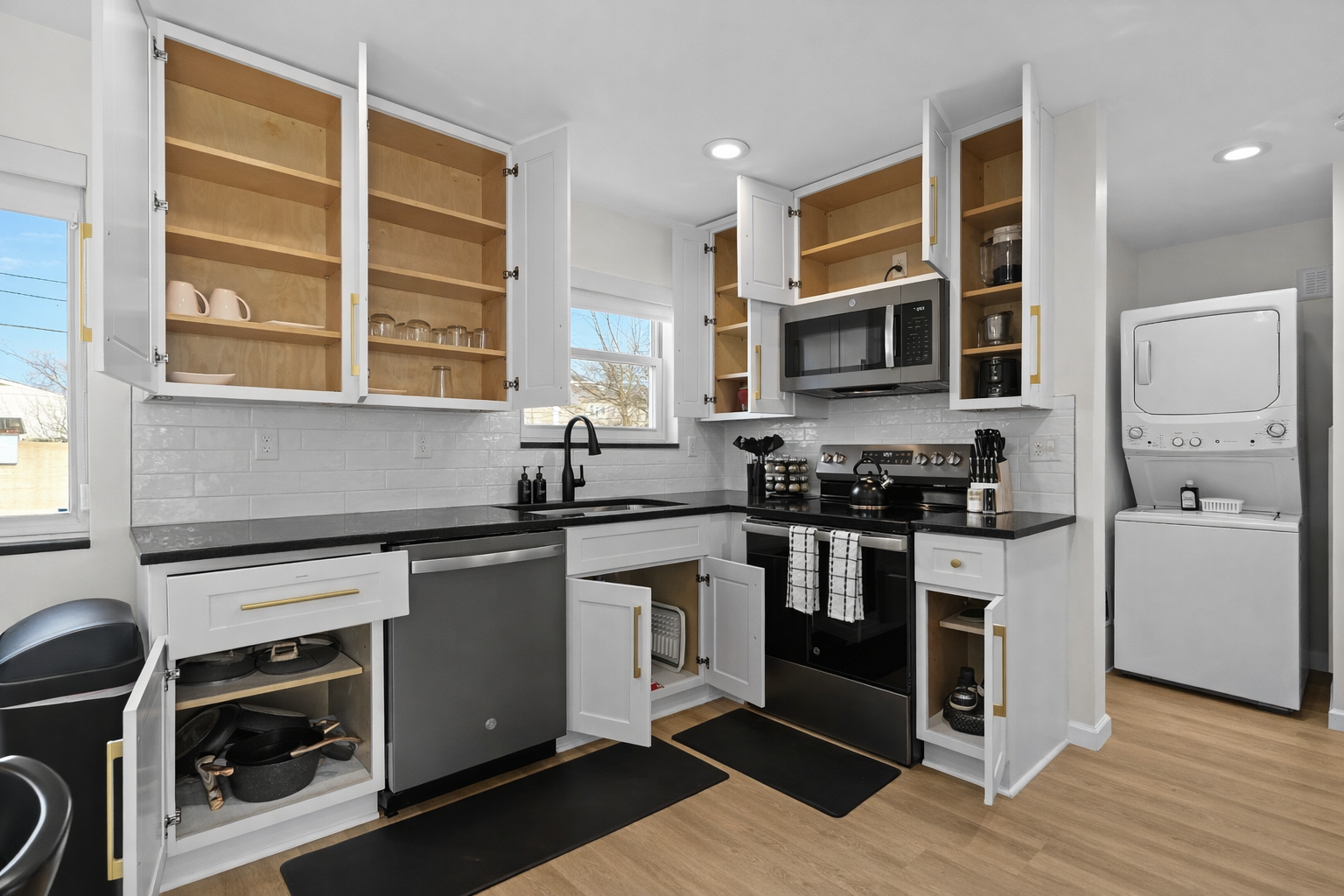 Well-stocked, modern kitchen with generous cabinet space, quality cookware, and in-unit laundry—perfect for both short and extended stays.