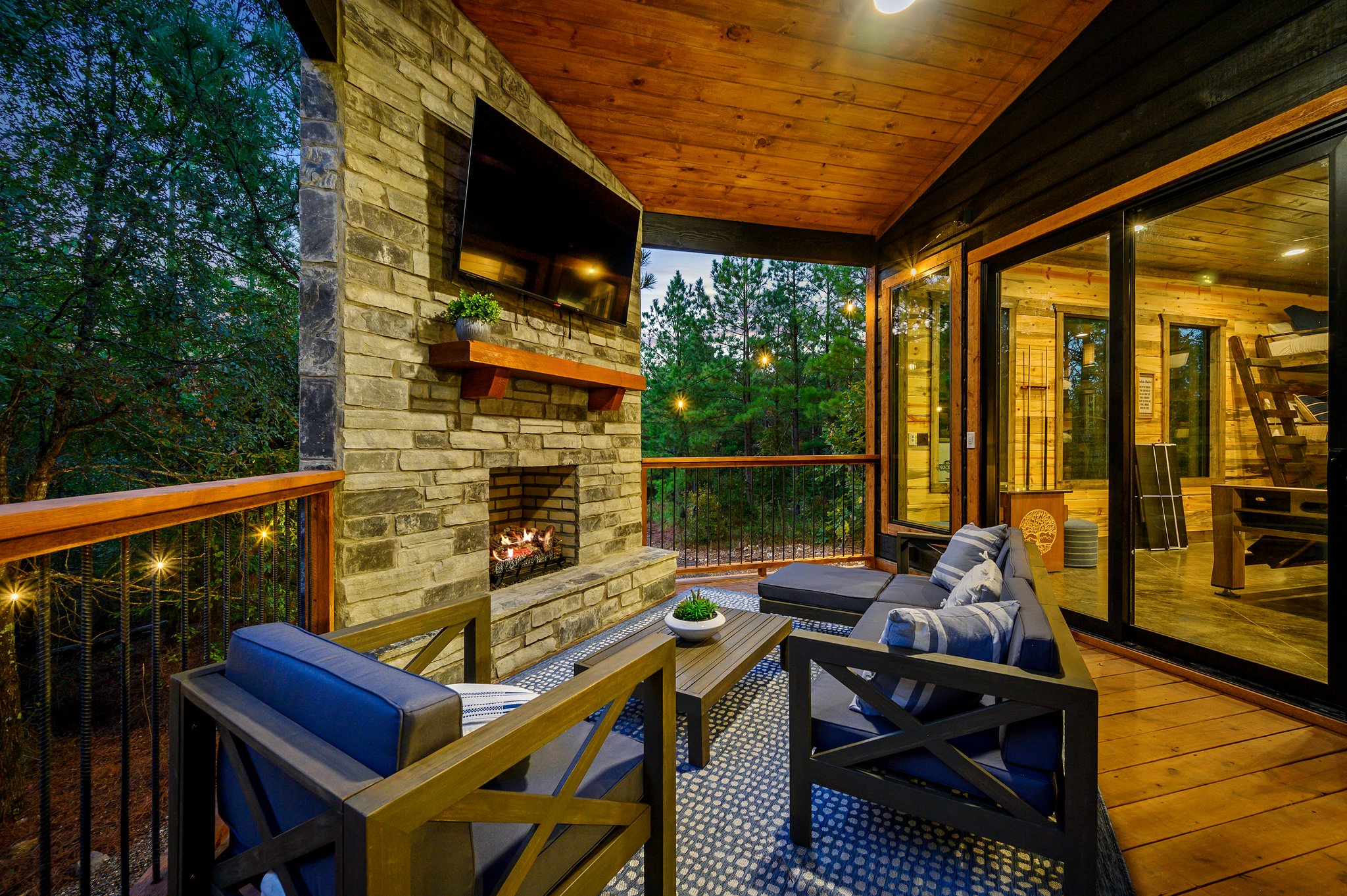 Modern luxury meets nature on this spacious, fire-lit covered deck.