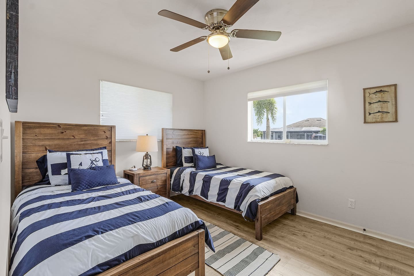 Second guest bedroom with coastal charm — 2 twin beds, TV, and a view of the water!