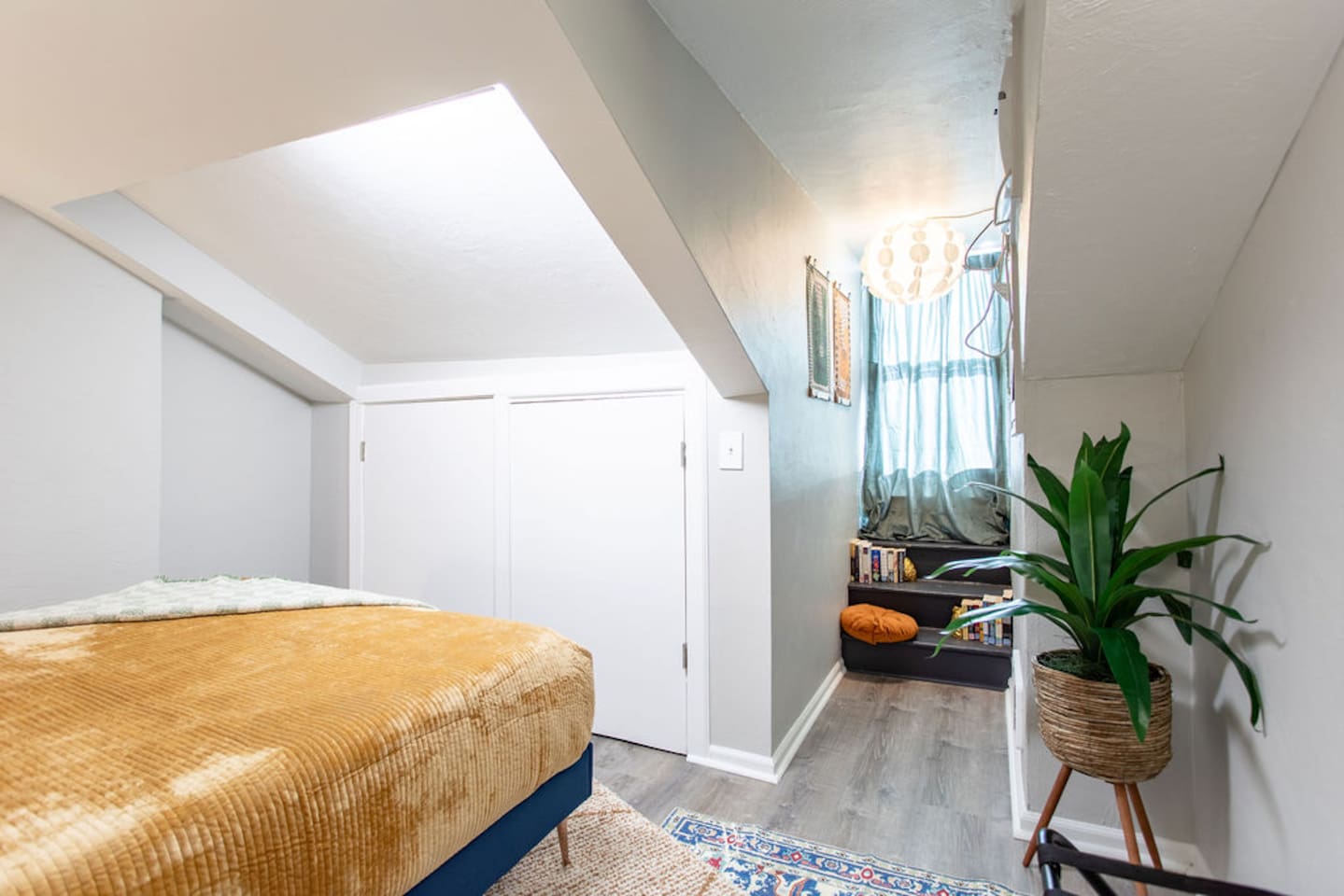 Cozy queen bedroom with bright accents, creating a cheerful and inviting atmosphere.
