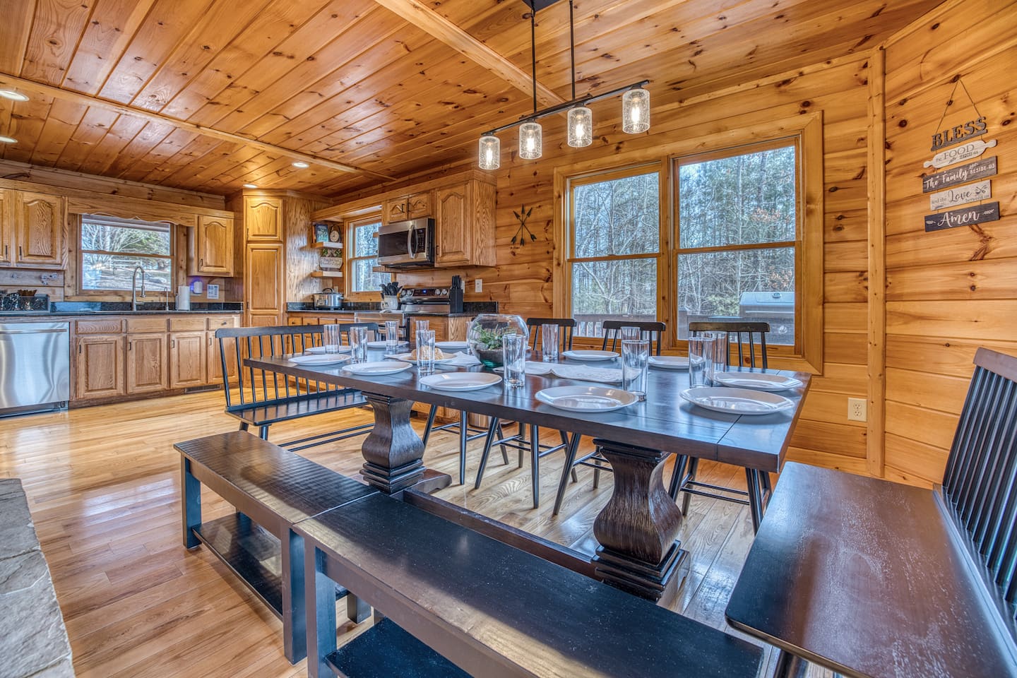 Dining area right off the fully-stocked kitchen that has seating for 12, with double-sided fireplace between dining area and living room.
