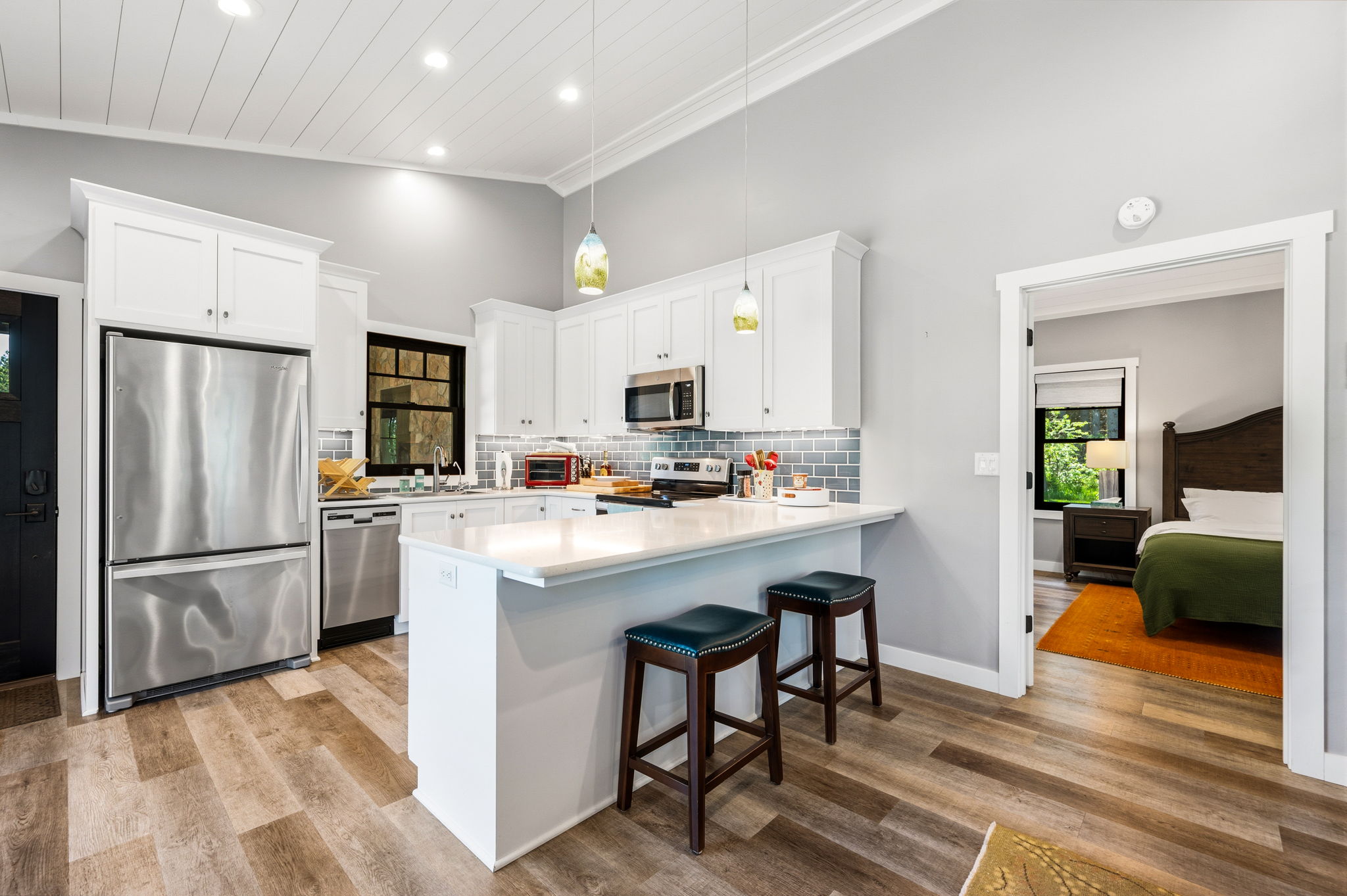 The heart of the home connects kitchen and bedroom, showcasing the bright open floor plan and easy livability throughout.