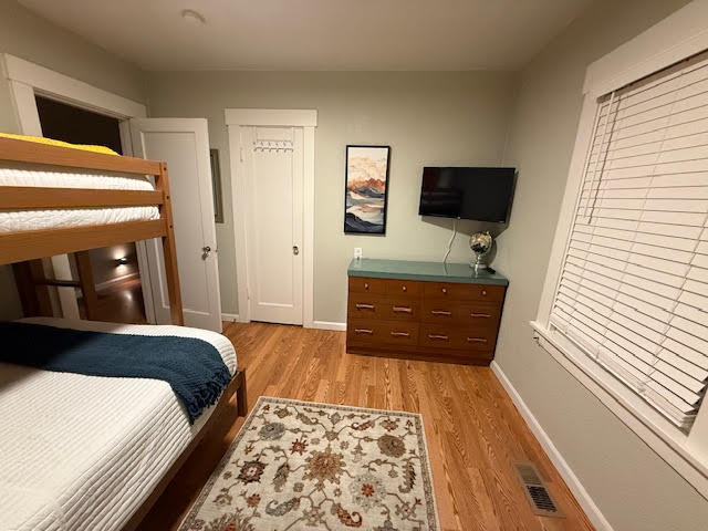 Bunk bed room with dresser and Roku TV