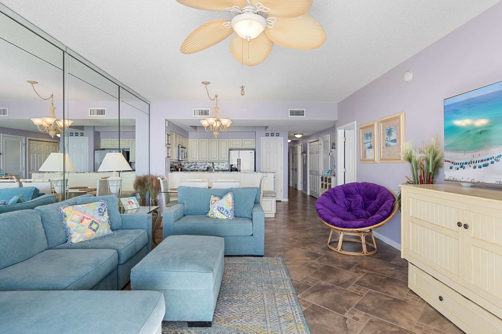 Inviting living room w/ plush sectional, TV & sliding doors opening to ocean views and fresh coastal breezes.