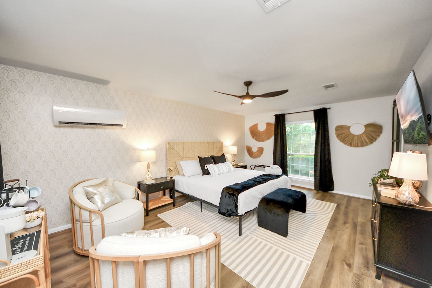 Primary bedroom downstairs complete with King size bed, sitting area, coffee cart and en-suite bathroom.