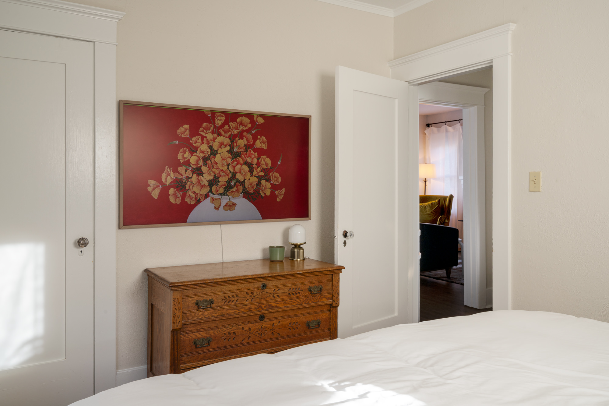 A large TV in the primary bedroom includes Sling, and is also an art TV to add to the decor when you are not watching.