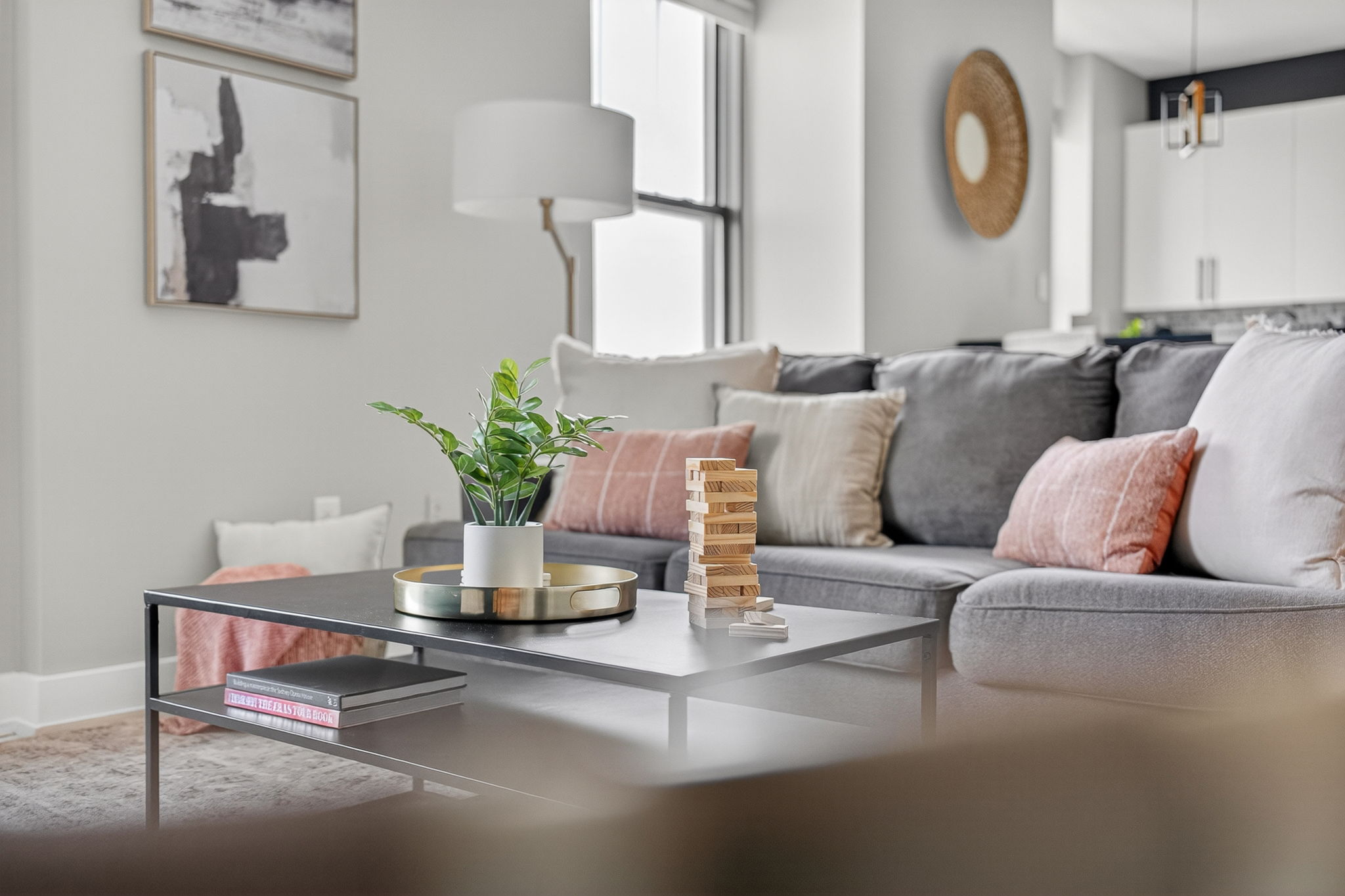 A curated balance of comfort and style—this lounge-ready space features a plush sofa, layered pillows, and a few thoughtful extras (like Jenga) for cozy nights in.