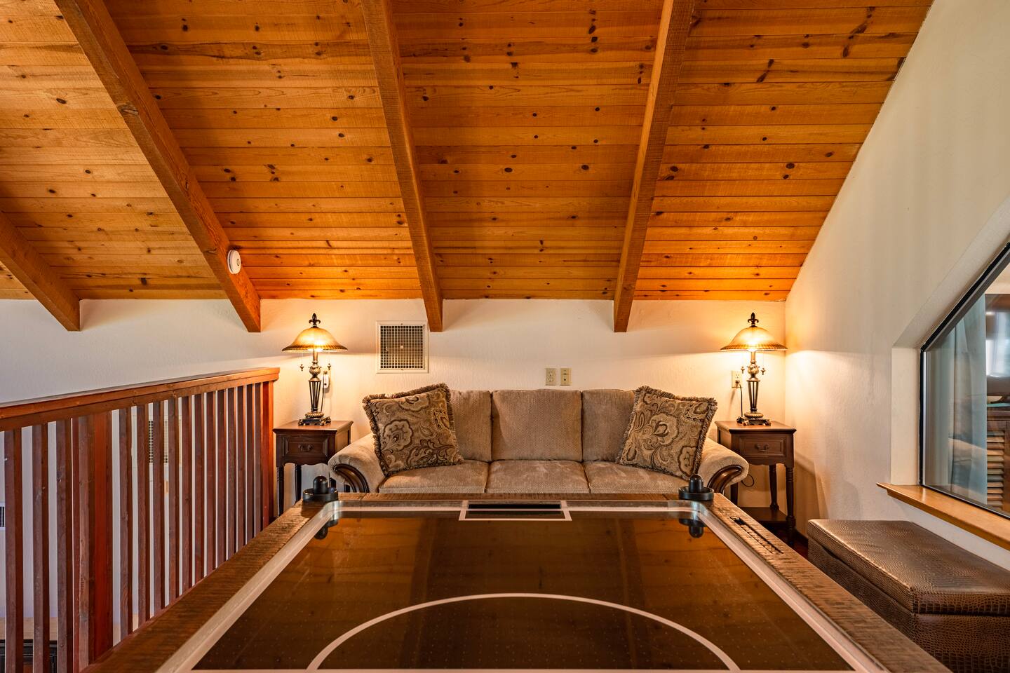 Loft with queen sofa sleeper and air hockey table