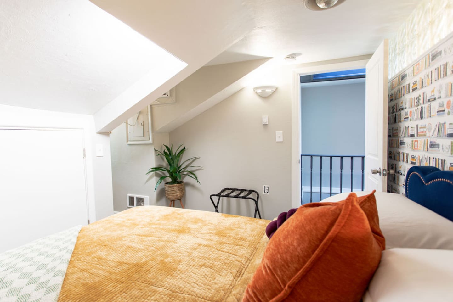 Cozy queen bedroom with bright accents, creating a cheerful and inviting atmosphere.