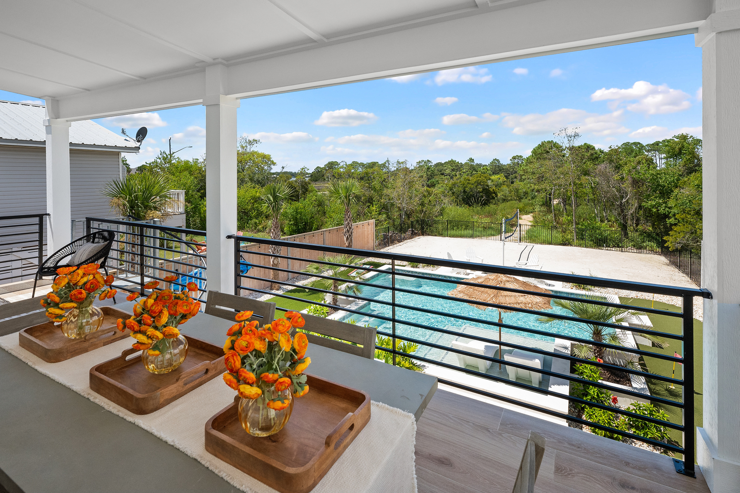 Covered balcony overlooking the private pool and backyard.