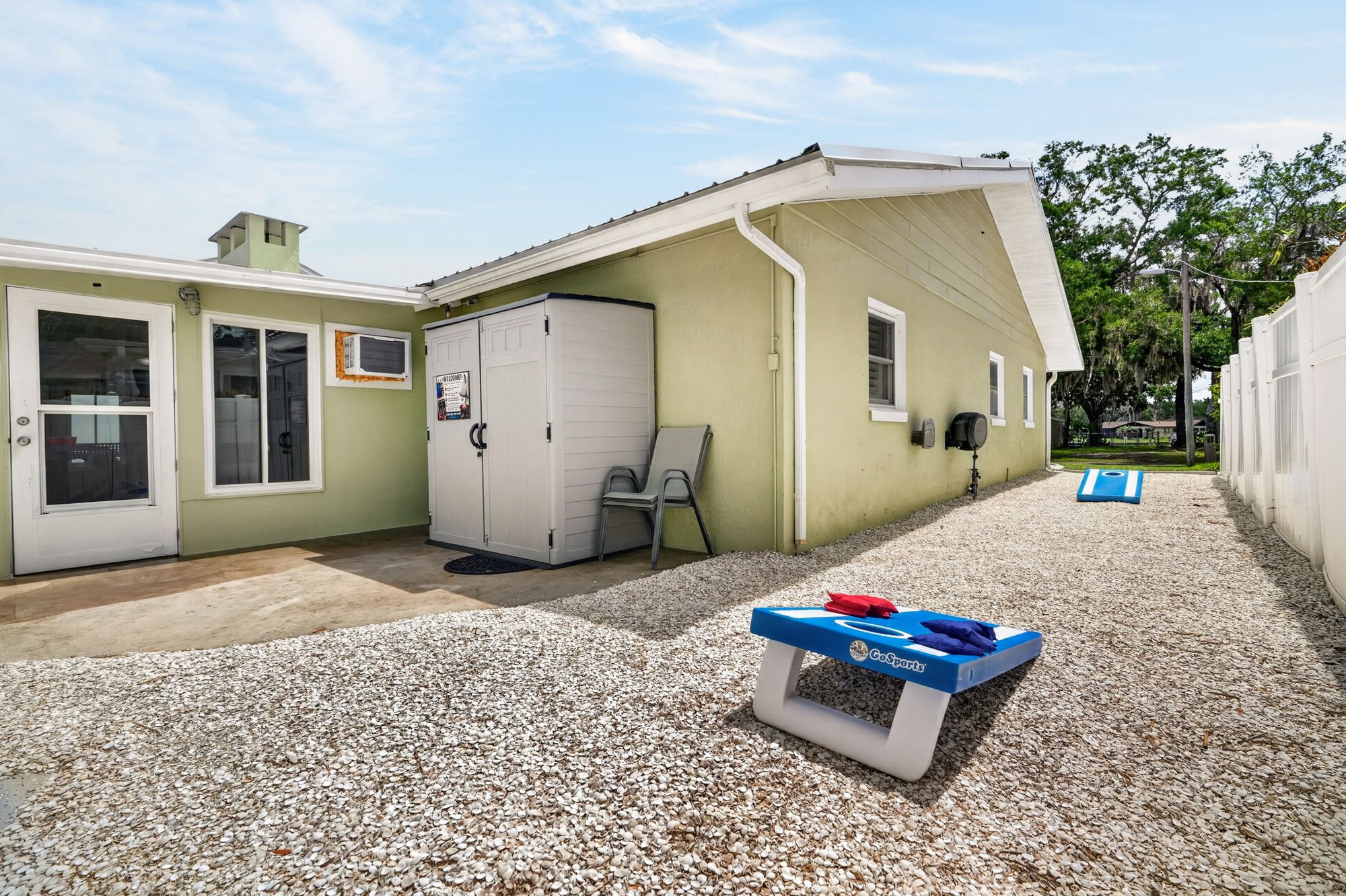 Storage shed exterior with cornhole boards