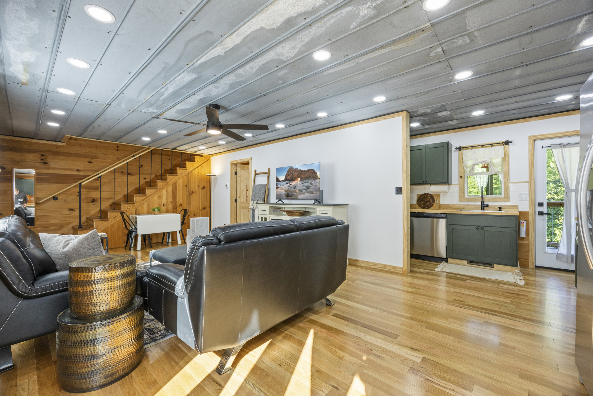 Alternate view of the living room showing the open layout flowing into the kitchen.