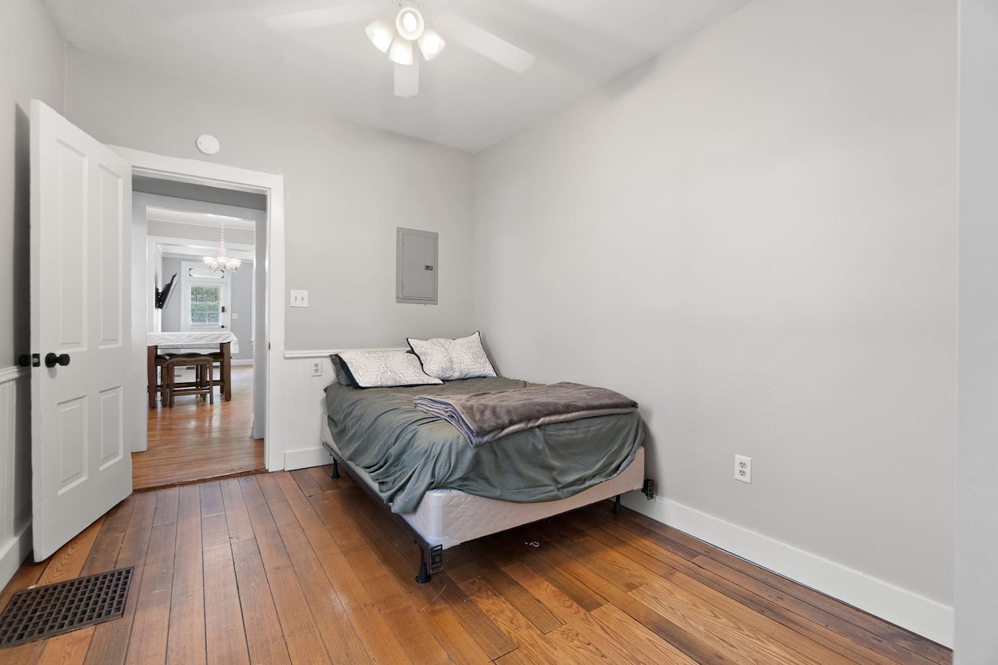 Charming bedroom conveniently located through the dining area, offering a seamless flow between spaces for easy access and an open, airy feel.