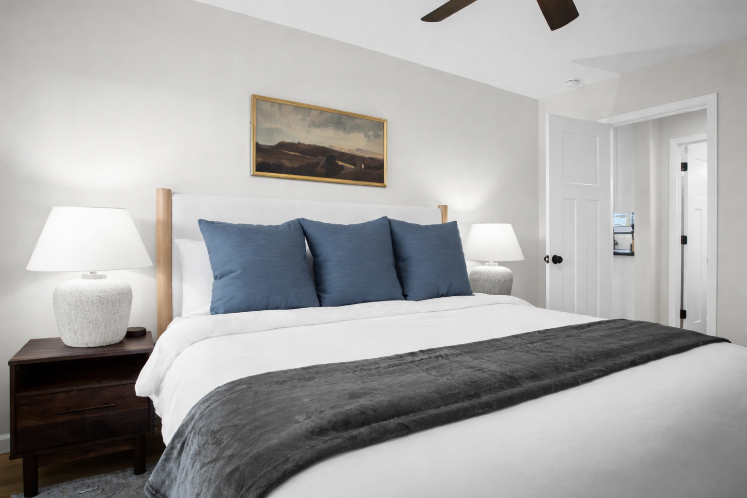 Bright, tranquil bedroom with a plush king bed, soft lighting, and modern décor—designed for restful sleep and peaceful mornings.