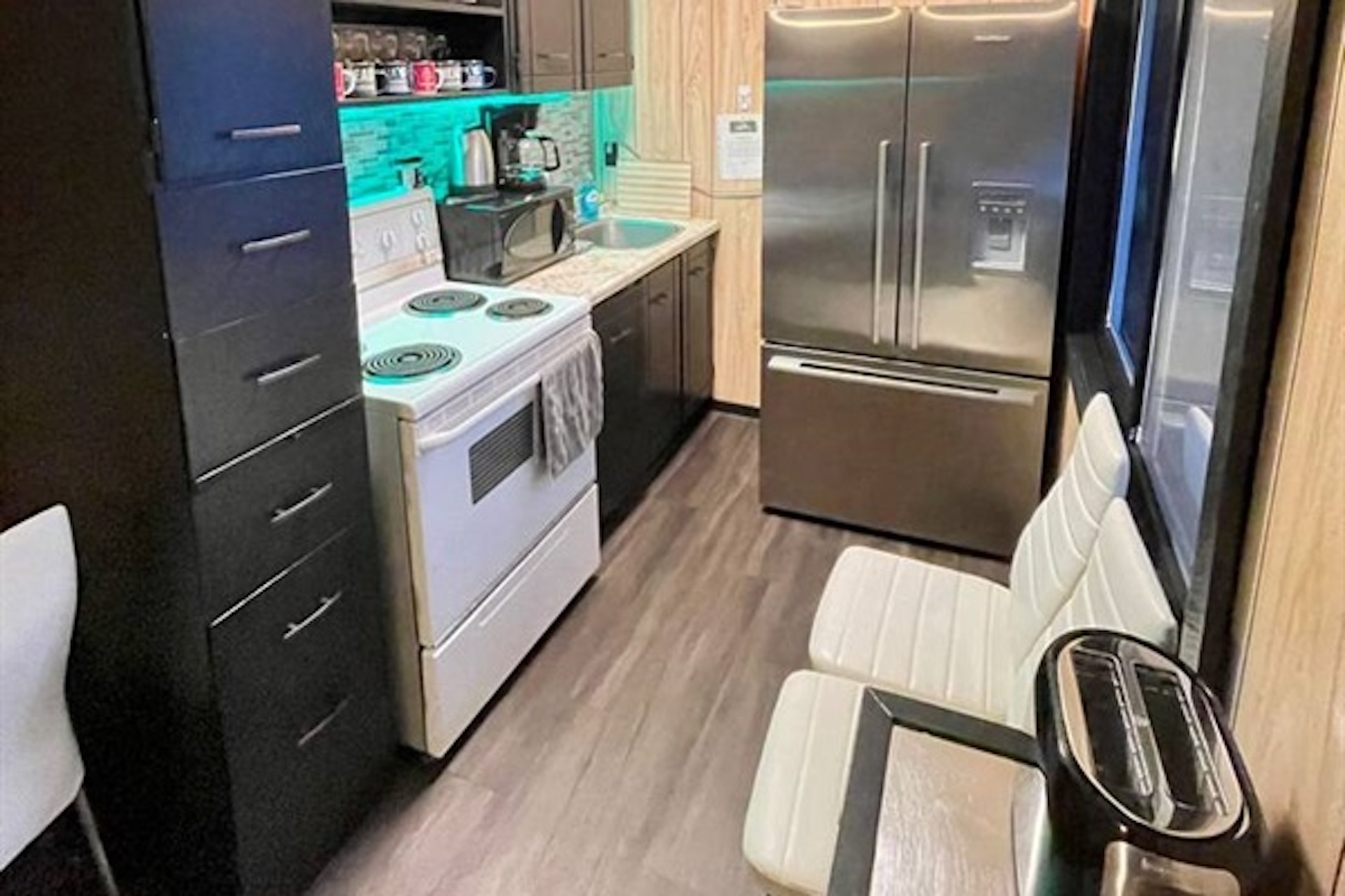 Compact kitchen with refrigerator, stove and ample storage