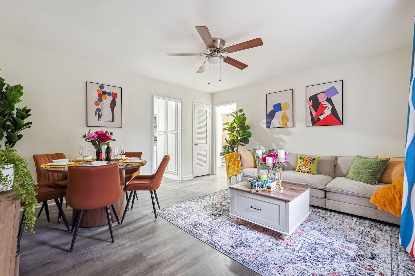 Enjoy a warm and inviting dining area combined with the living room, featuring a dining table set where you can enjoy meals while watching TV. The space also includes a ceiling fan for extra comfort and a cozy atmosphere for gathering and relaxing.
