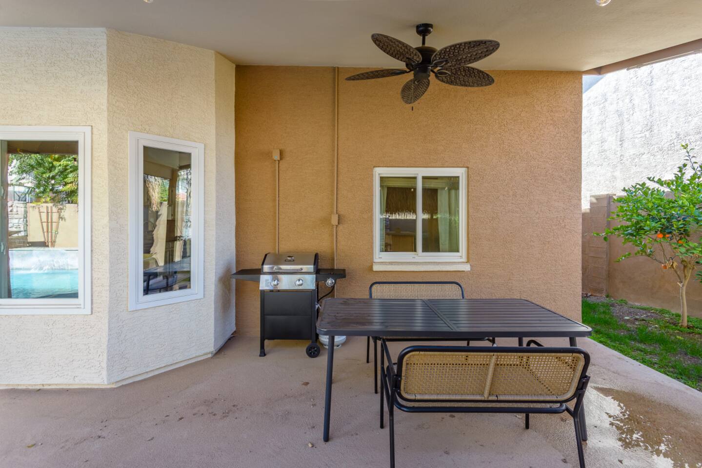 Covered outdoor seating area with window views and easy access from the home.