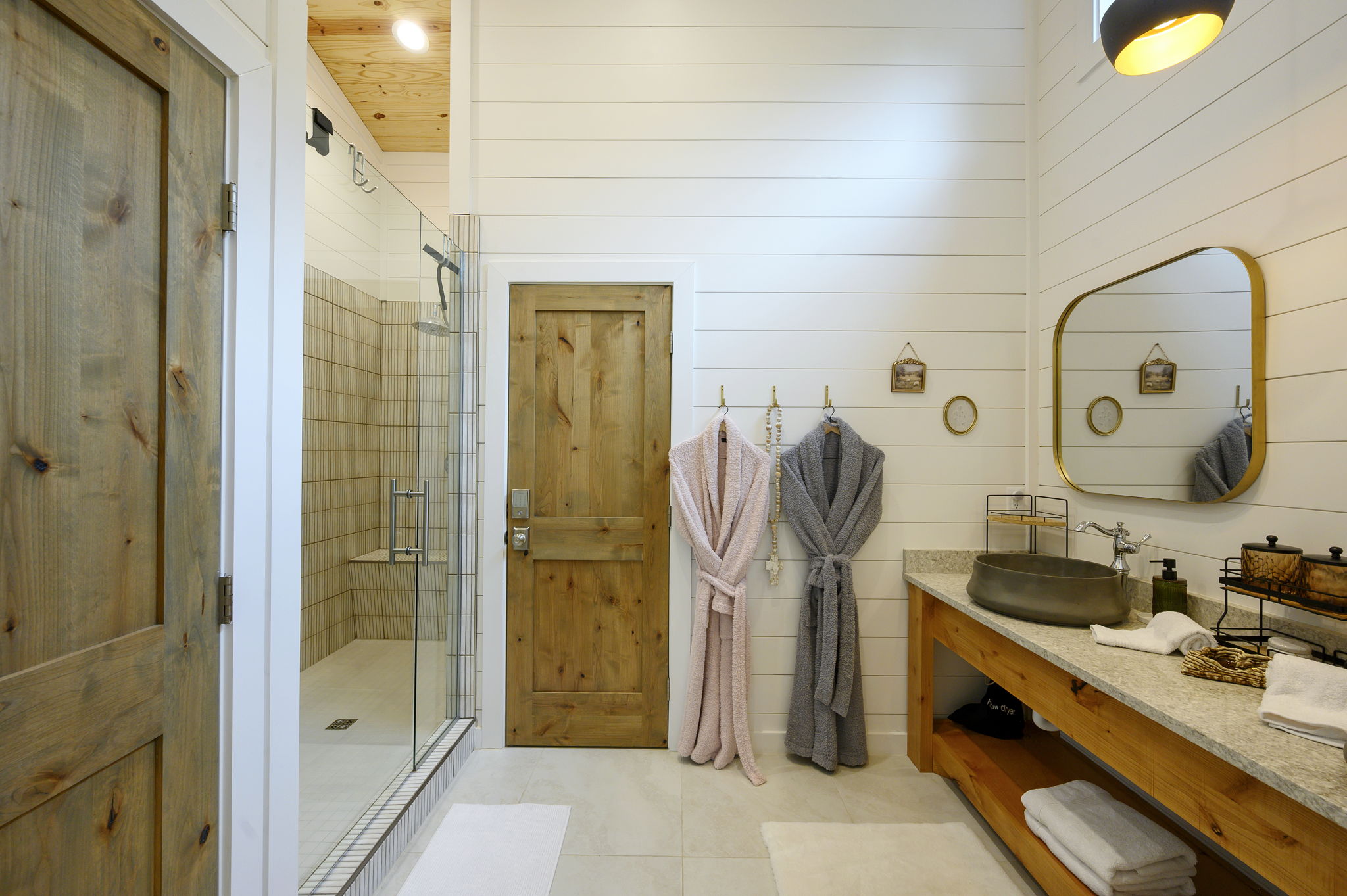 The primary ensuite bathroom offers a warm, spa-like experience with high-end finishes, luxurious touches, and a serene atmosphere designed for comfort and relaxation.
