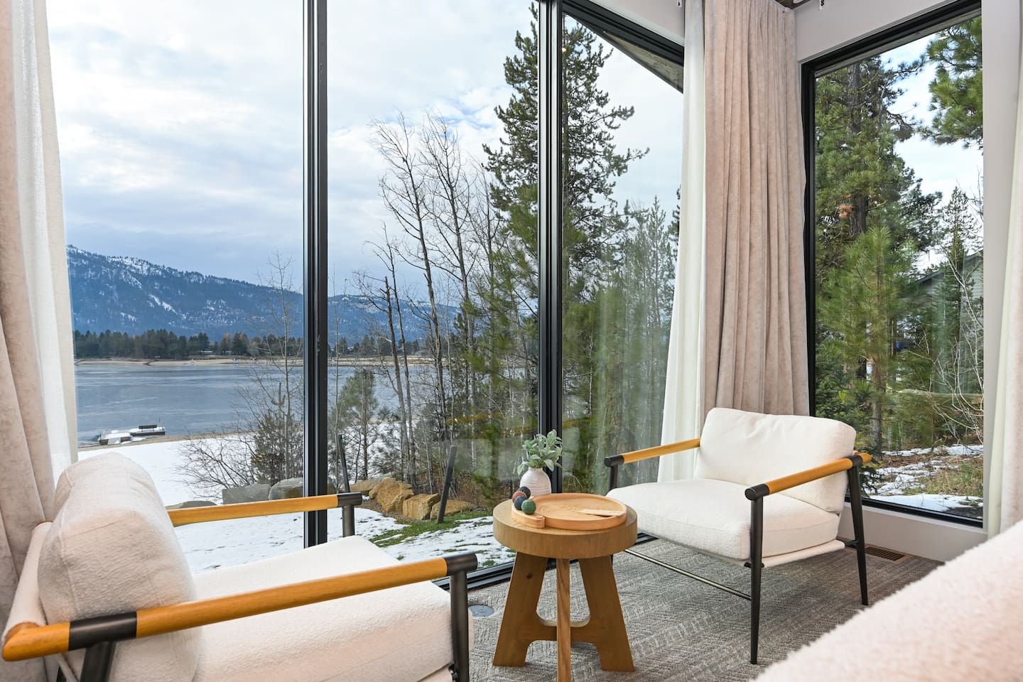 A comfy corner with big windows and relaxing views of the lake and mountains