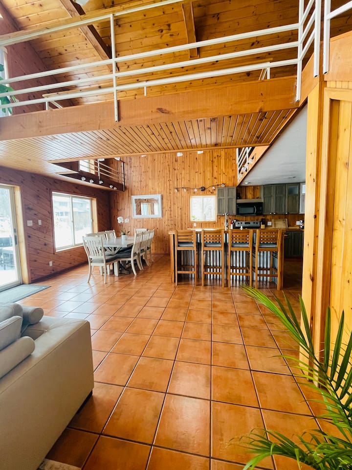 Spacious open-concept living and dining area with vaulted ceilings.