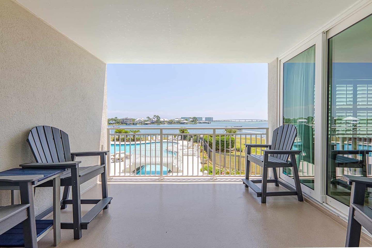 Balcony Retreat: Unwind with stunning views of the pool and tranquil bay—perfect for sunset sips!