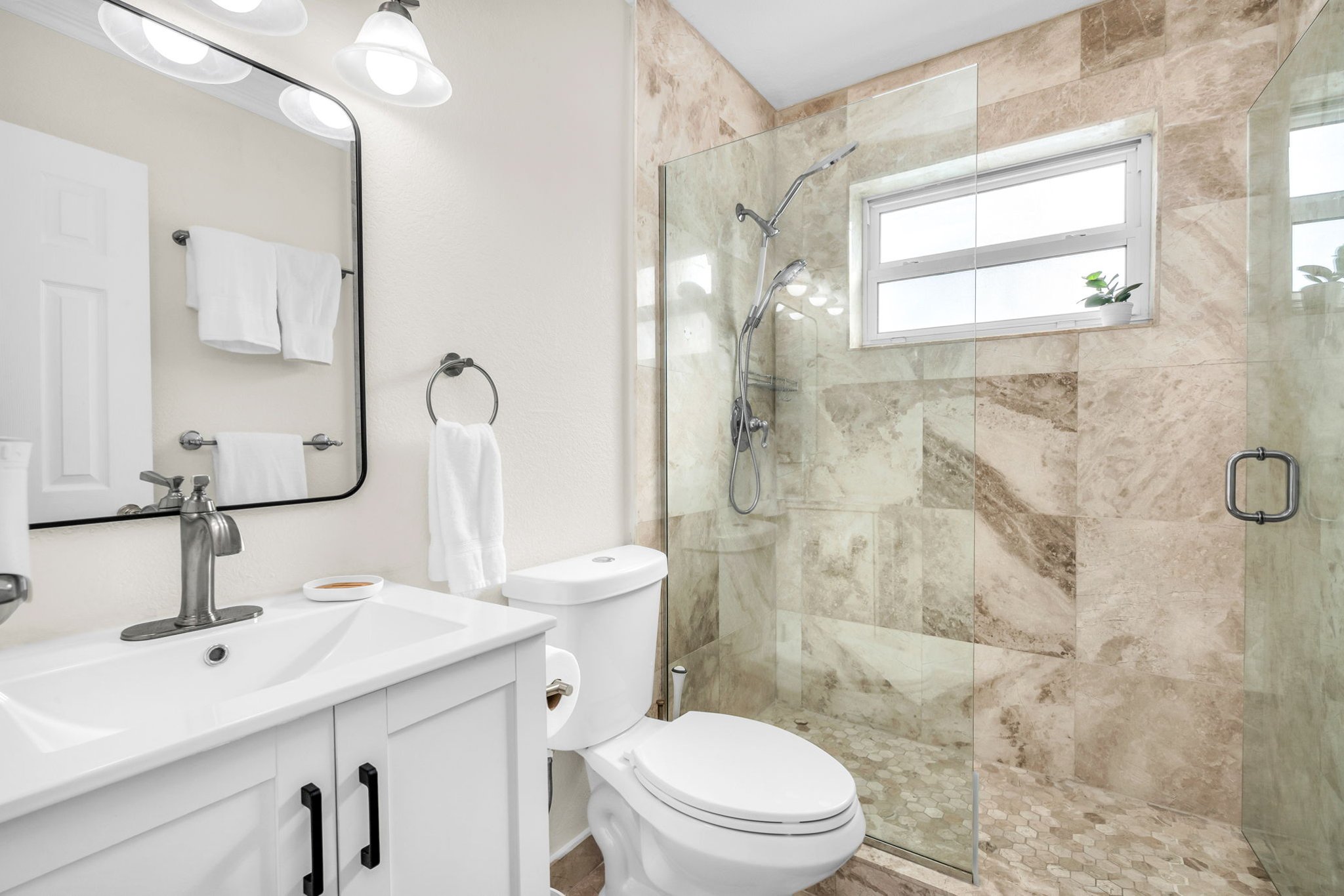 2nd Updated bathroom featuring a glass walk-in shower, modern vanity, and fresh design