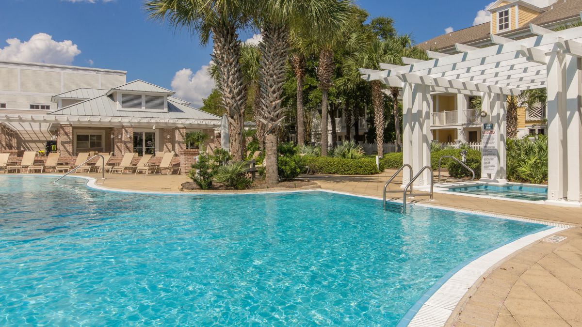 Pilot House lagoon-style pool with palm trees, loungers and the hot tub pergola