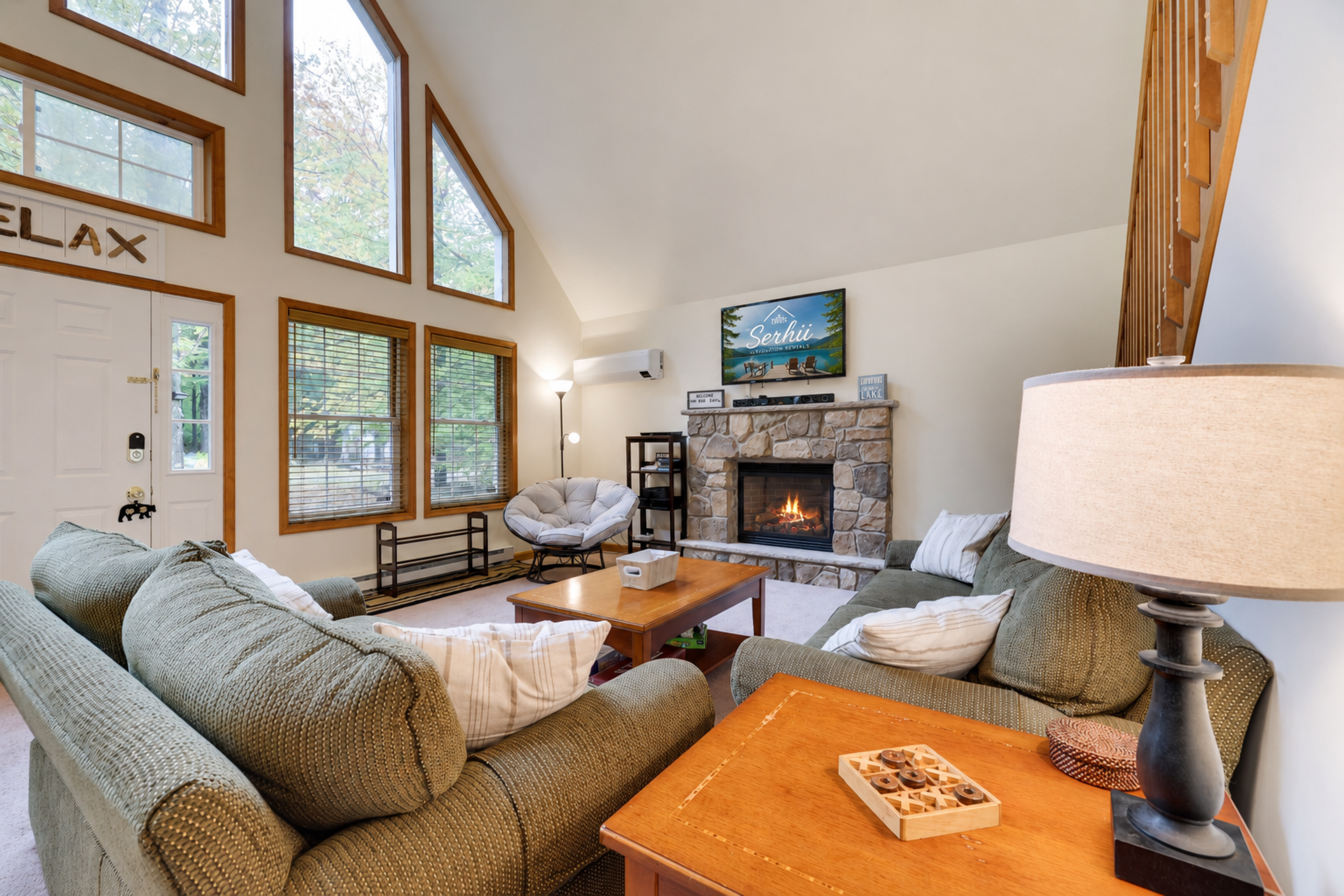 Living room with high ceilings, comfy couches and propane fireplace - Serhii Vacation Rentals