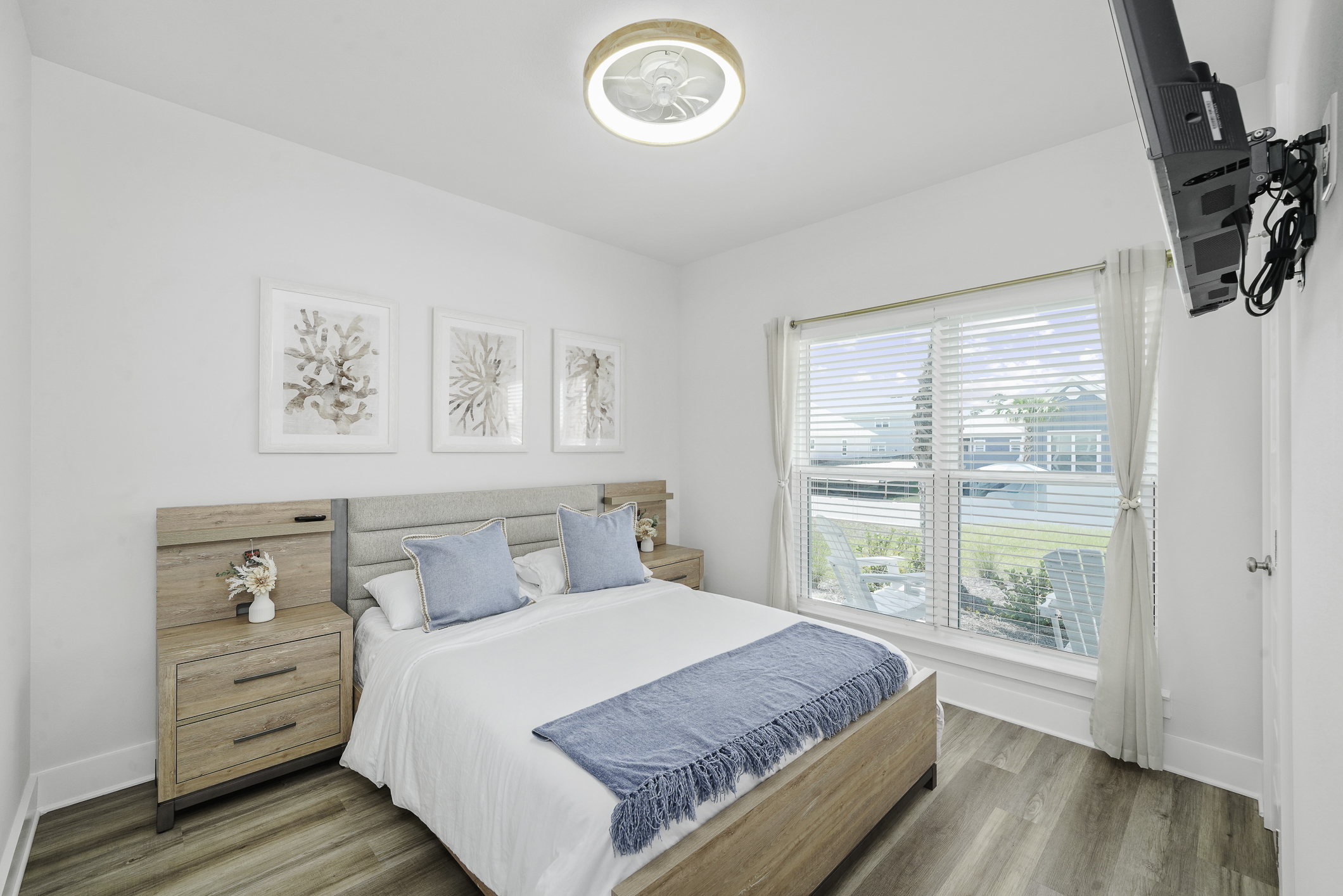 Bedroom 2: Bright Queen bedroom, comfy linens, ceiling fan, elegant bedside lamps, wall art, and Smart TV.