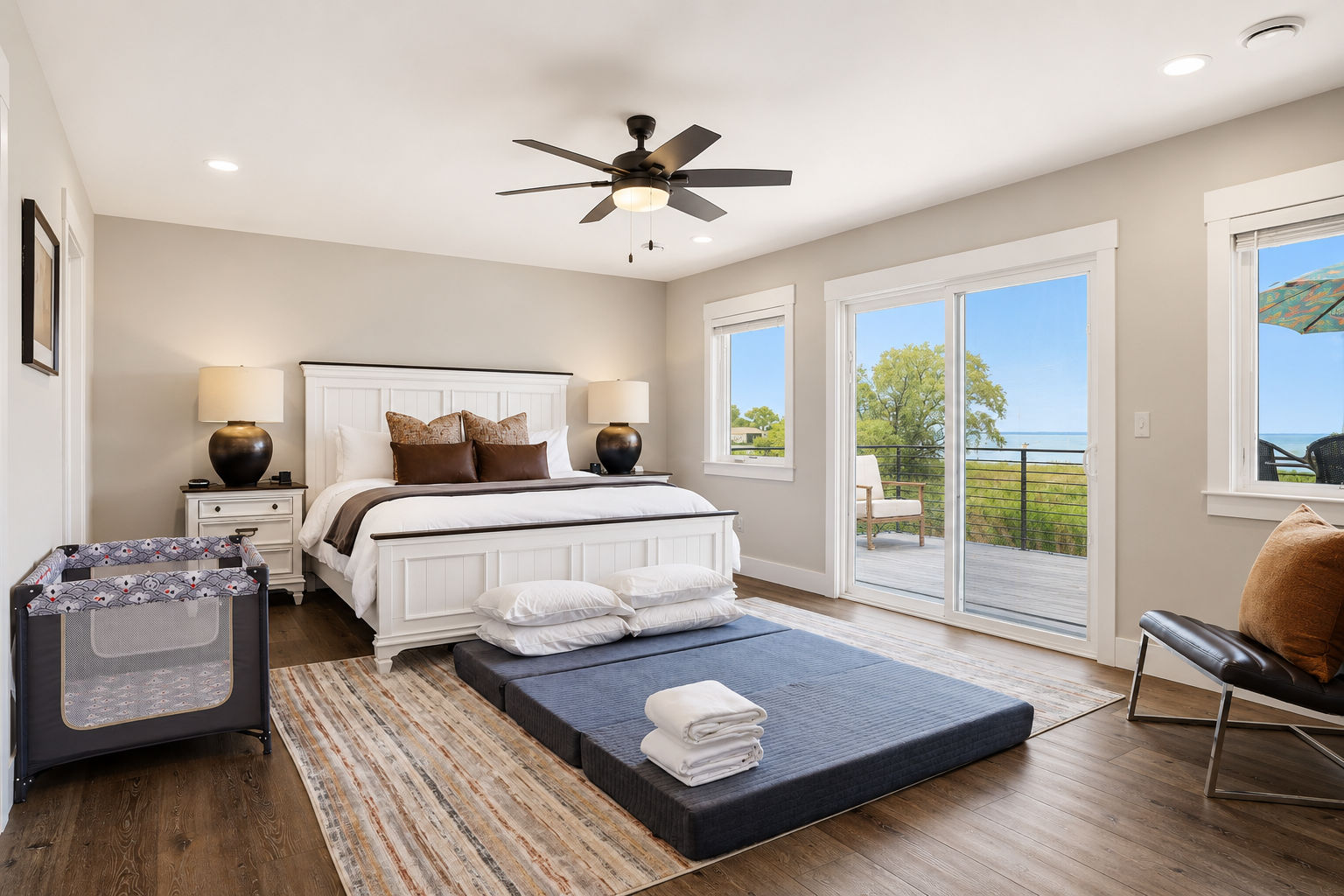 Experience waterfront living at its finest. This serene primary suite features a plush king bed and private veranda overlooking Lake St. Clair, creating the perfect setting for a peaceful and memorable stay.