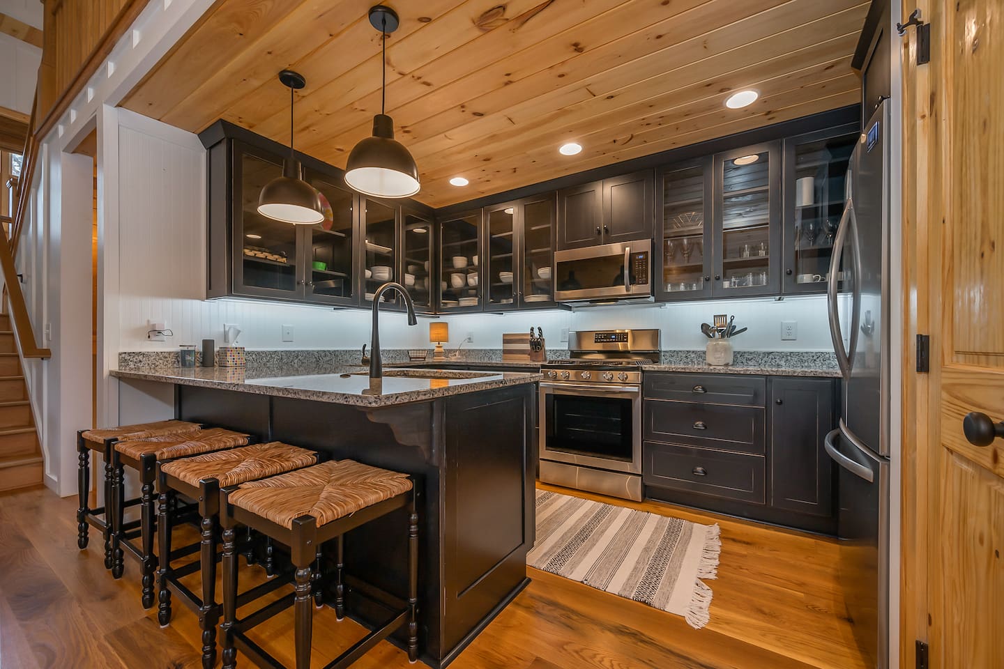 Upgraded kitchen area with stainless steal appliances and seating area