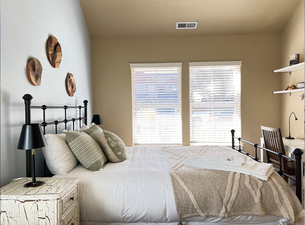 This bedroom has a queen bed and is located on the first floor, featuring a small workspace. It is bright and cozy!