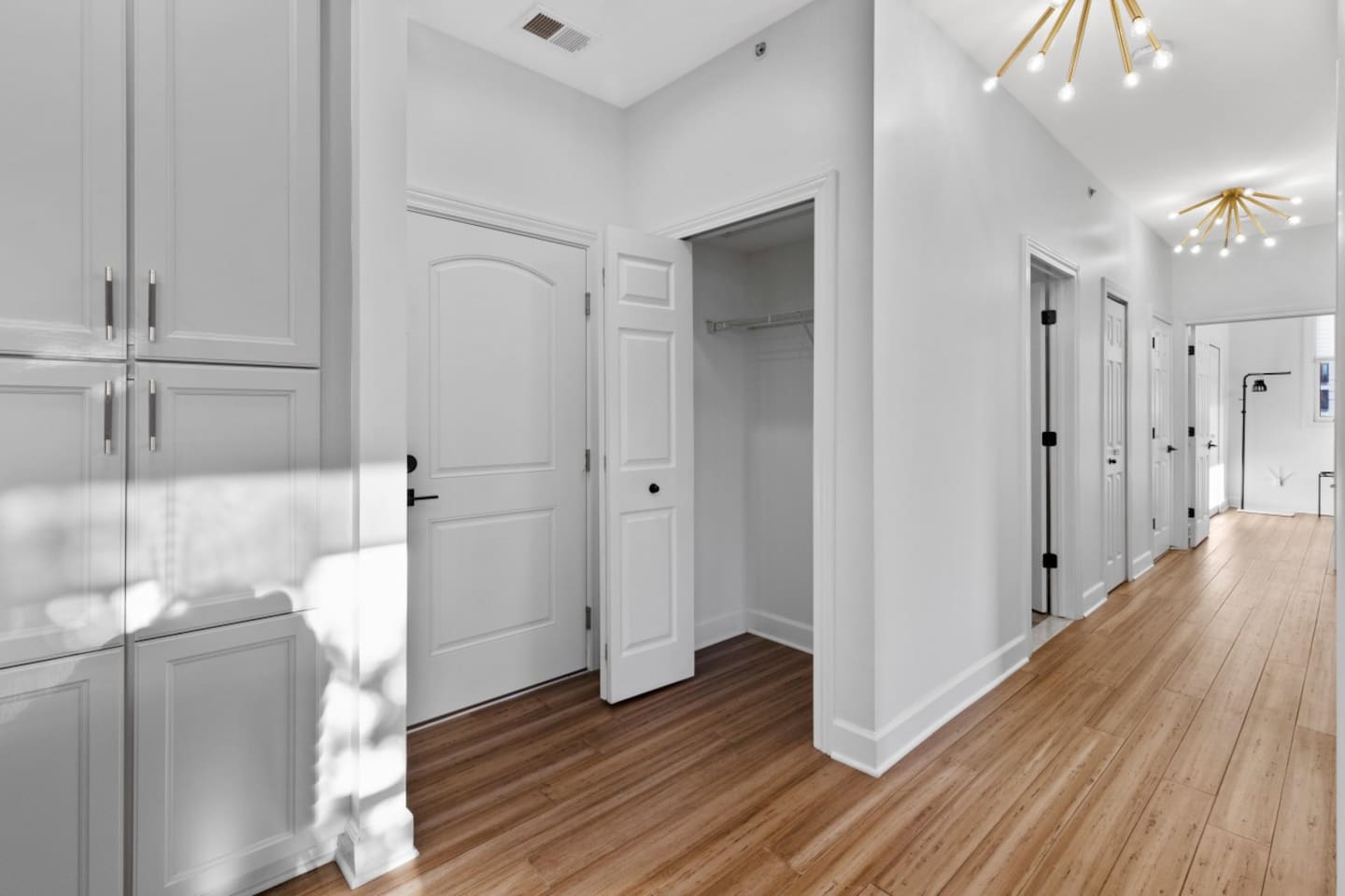 Enjoy a sleek hallway with stylish storage and contemporary lighting.
