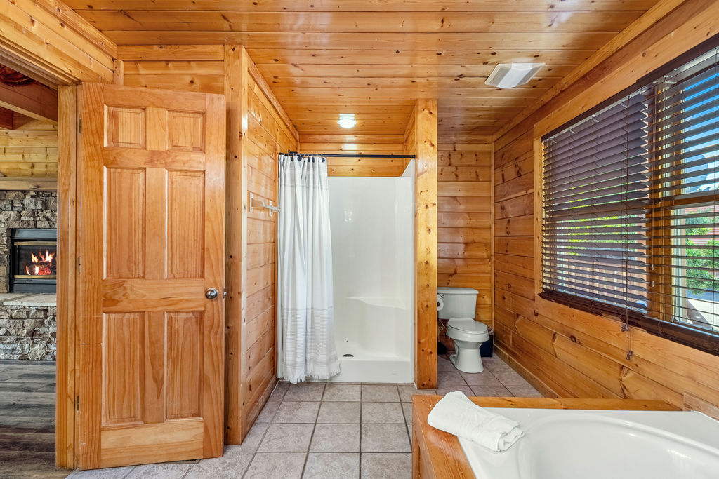 Refresh in the spacious walk-in shower, where sleek design meets mountain comfort for the perfect post-adventure escape.