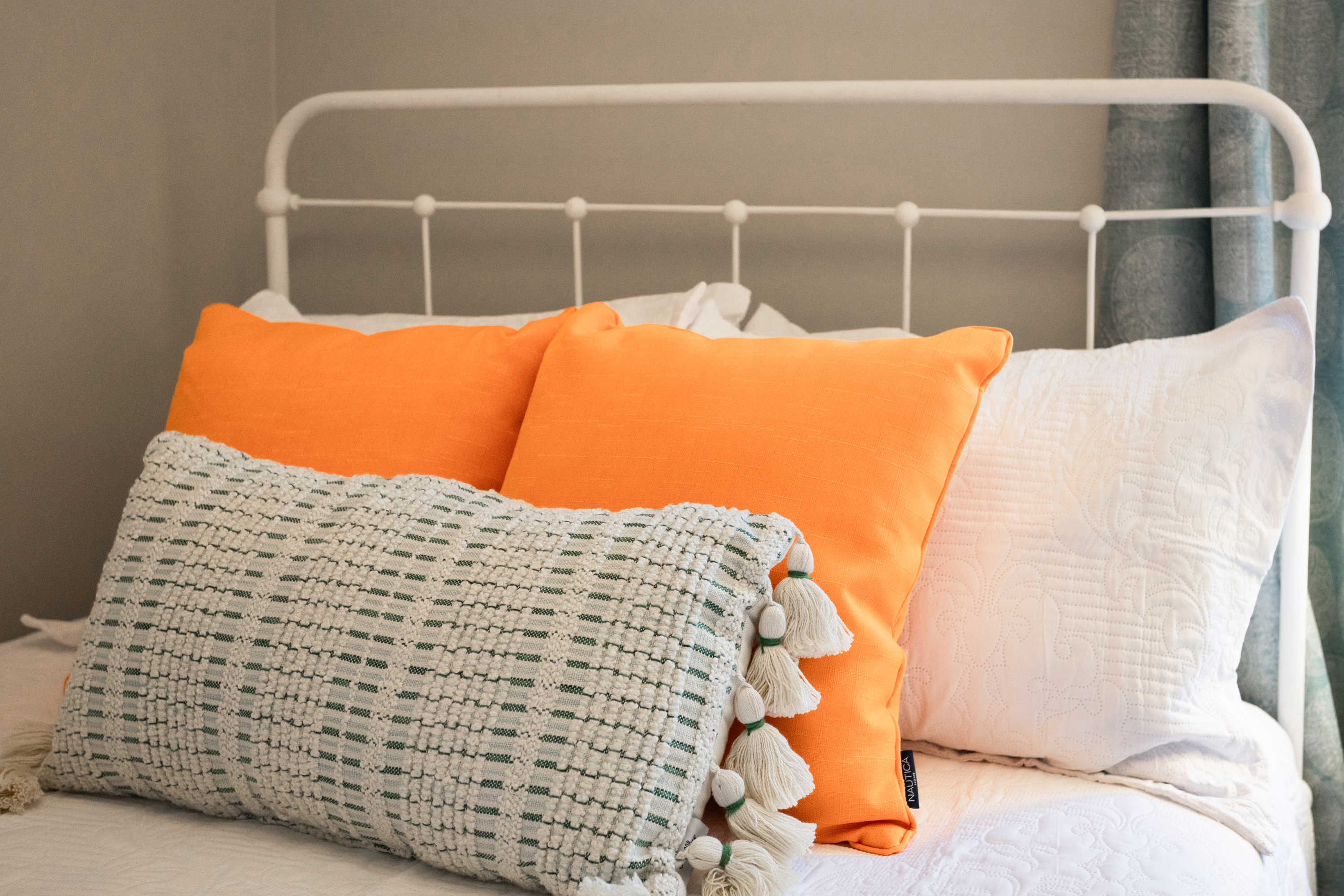 Fresh white linens and colorful accents create a welcoming retreat.