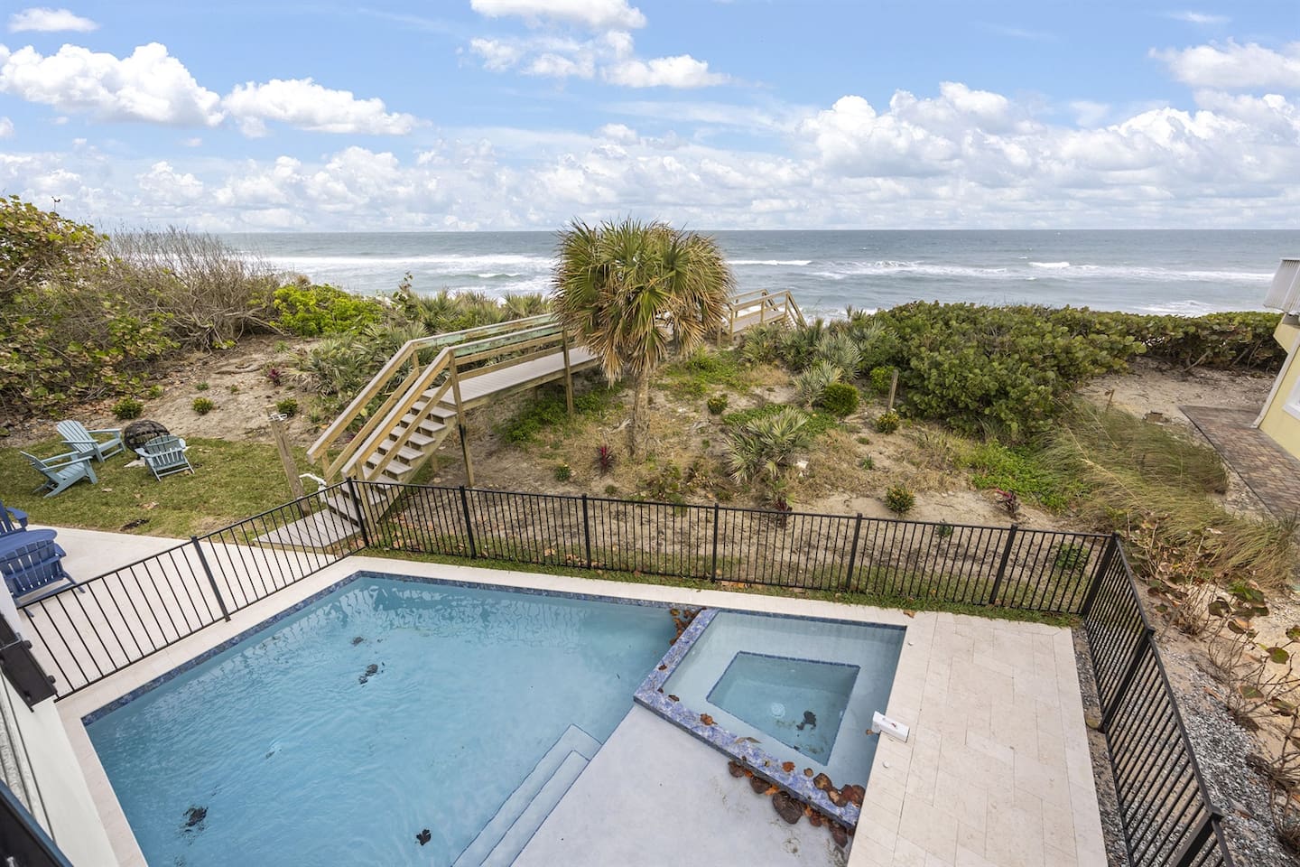Step outside to the stunning exterior of the house, featuring a sparkling swimming pool with a breathtaking view of the ocean, offering the perfect spot to relax and take in the natural beauty of the surroundings.