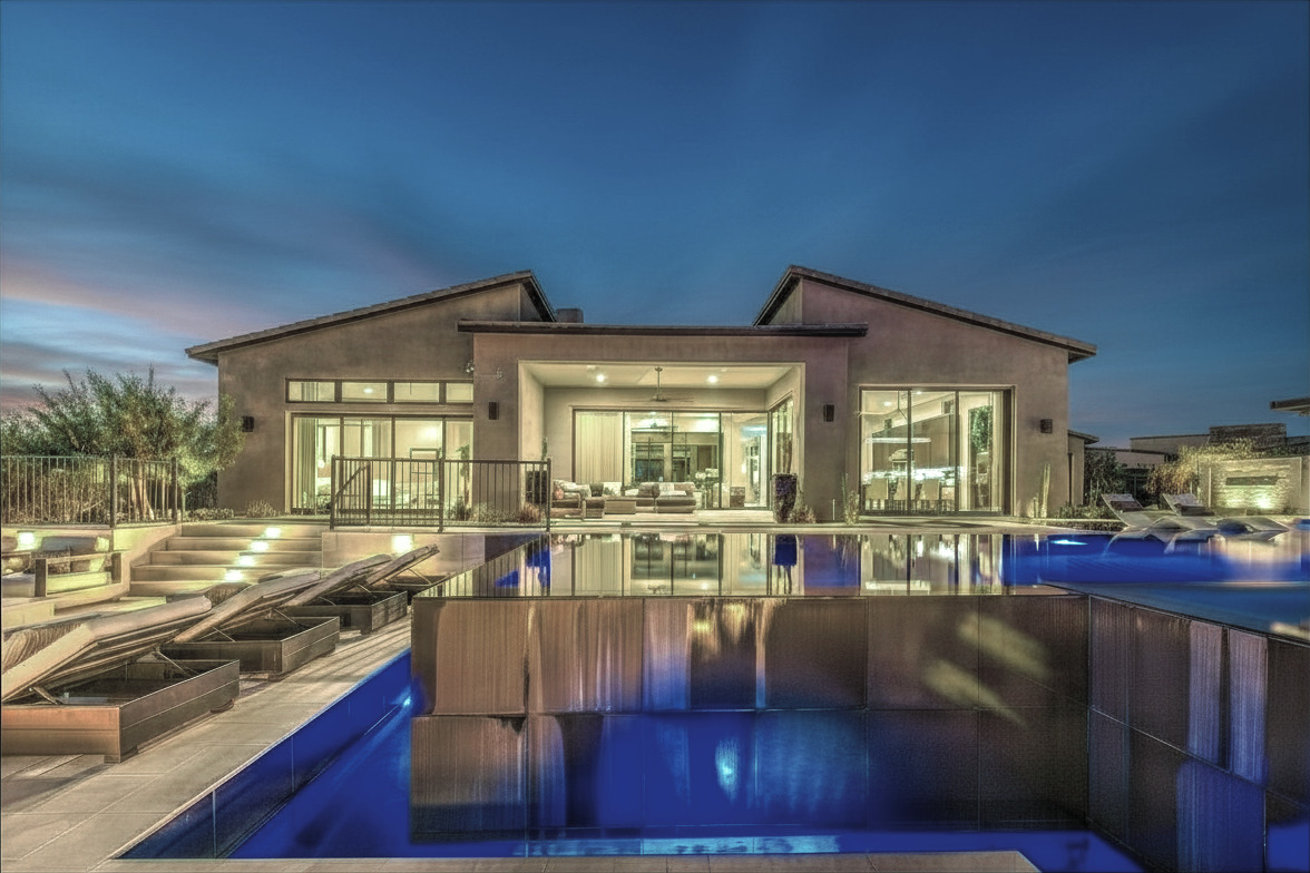 A masterfully lit private oasis designed to unwind by the illuminated water.