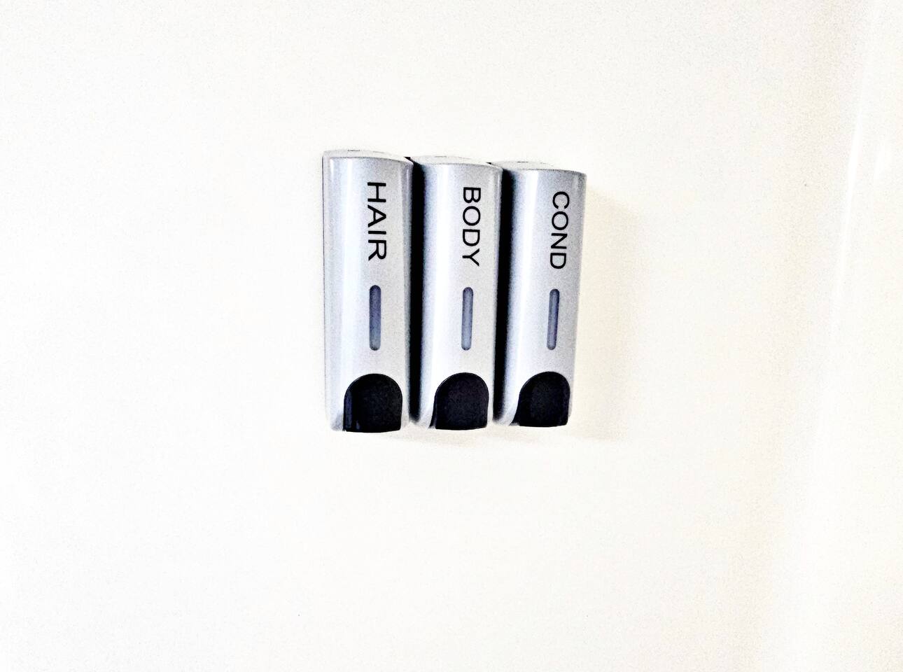 Shampoo, conditioner, and body wash dispensers are provided in each bathroom. 