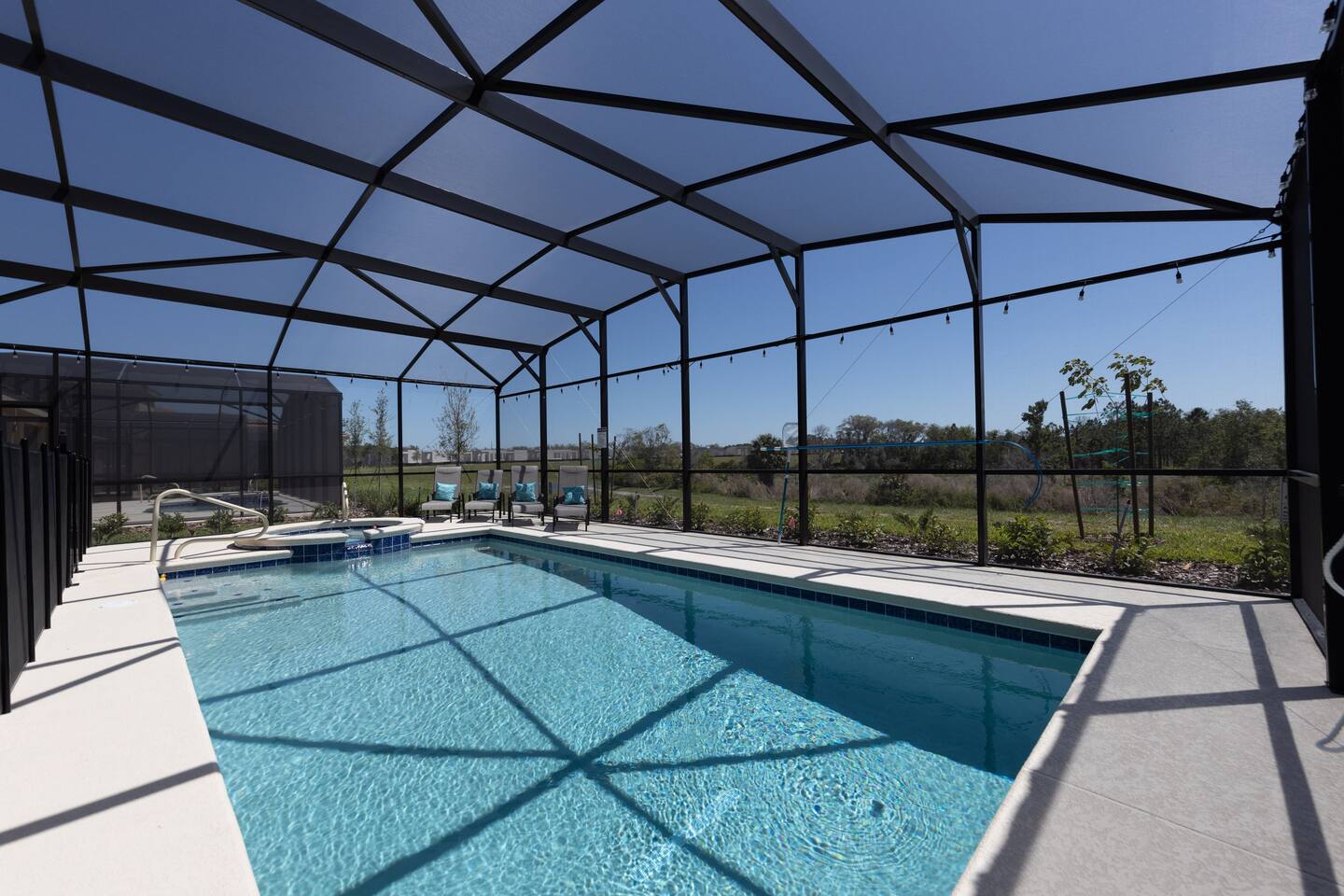 Oversized heated pool, complete with hot tub with four chaise lounge chairs. Pool comes with colored LED lights to ensure any night swims magical. 