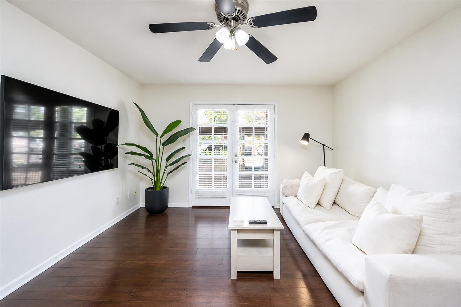 Relax indoors with a bright living area, sofa seating, Smart TV, and coffee table.
