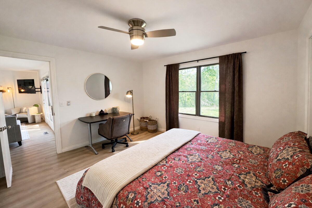 A serene bedroom with soft, layered bedding — a peaceful place to recharge.