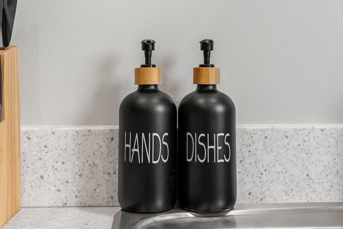 Stylish hand soap and dish soap dispensers add a clean and modern touch.