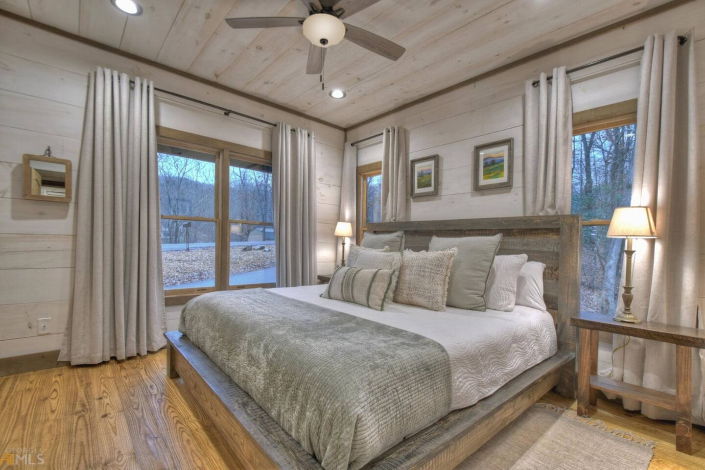 Main floor bedroom with king bed and TV