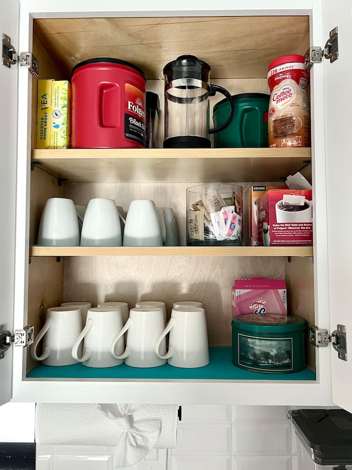 Stocked kitchen with coffee, decaf coffee, tea, cream and sugar.