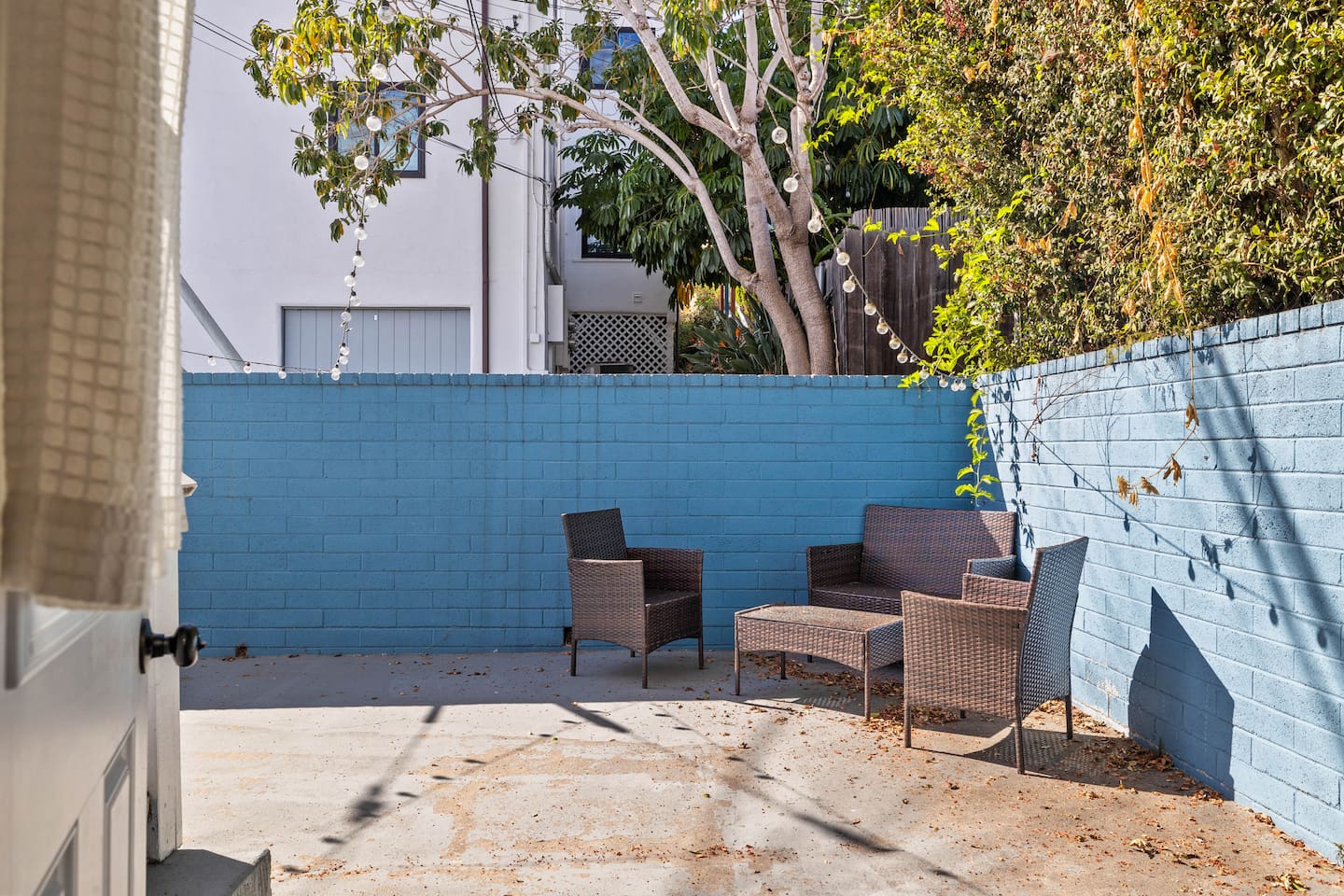 The exterior boasts a spacious outdoor area with a large wooden table and three smaller wooden tables, perfect for gatherings. Surrounded by natural beauty, this wide, open space invites you to relax and enjoy the fresh air.