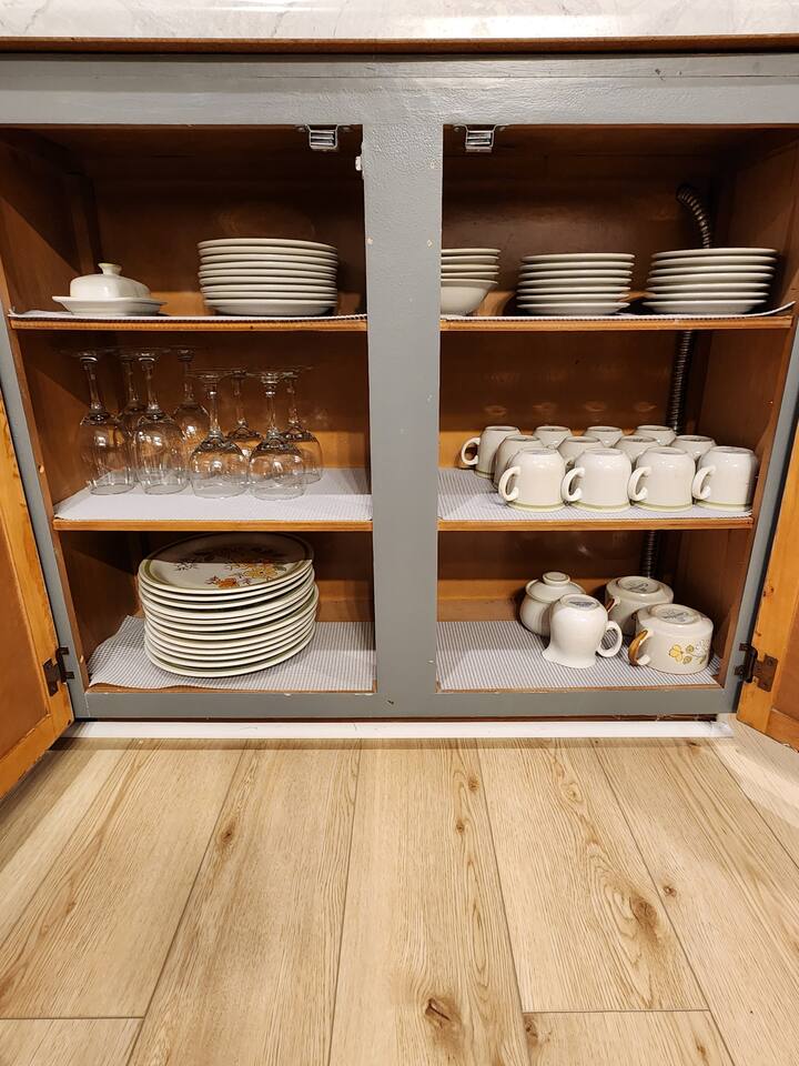 Wine glasses and additional dishes under the counter.