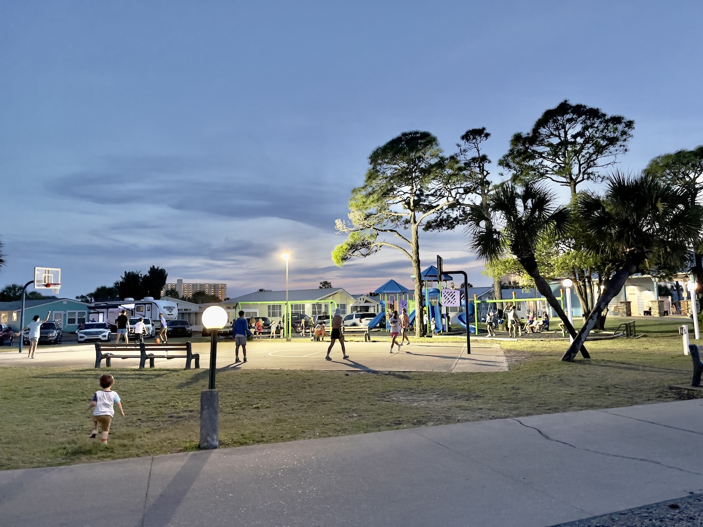 The kids gather at the basketball courts and playground by the bay every evening.