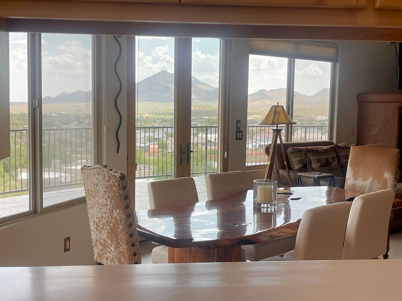 Gather around the table for meals, conversations, and time together, with natural light and mountain views just beyond the glass doors.